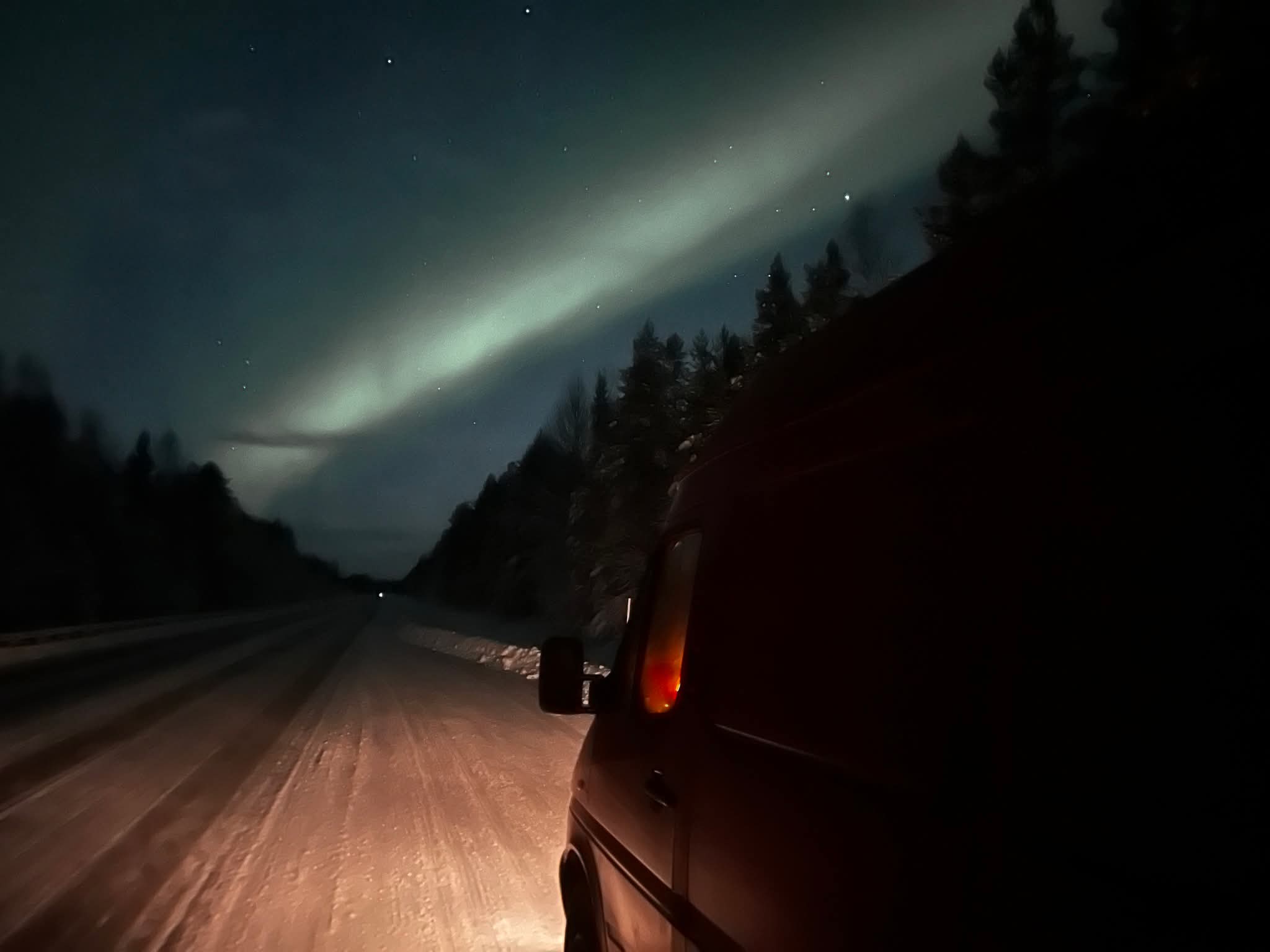 Van under northern lights